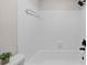 Bright bathtub with tiled walls and new showerhead at 3066 Chastain Park Ne Ct, Atlanta, GA 30342