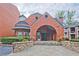 A handsome red brick building with a charming archway entrance creates a welcoming sense of arrival at 3066 Chastain Park Ne Ct, Atlanta, GA 30342