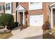 Townhouse entry with green door and attached garage at 3072 Lauren Parc Rd, Decatur, GA 30032