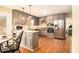 Well-lit kitchen with stainless steel appliances, gray cabinets, and a cozy breakfast area with hardwood floors at 1514 Howell Highlands Dr, Stone Mountain, GA 30087