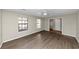 Bright living room with wood-look flooring and two windows at 6972 Vesta Brook Dr, Morrow, GA 30260