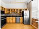 Modern kitchen with light wood cabinets, stainless steel appliances, and tile backsplash at 800 Peachtree Ne St # 8607, Atlanta, GA 30308