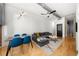 Open living area with hardwood floors, gray sectional sofa, and dining table at 800 Peachtree Ne St # 8607, Atlanta, GA 30308