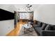 Open living area with hardwood floors, gray sectional sofa, and kitchen at 800 Peachtree Ne St # 8607, Atlanta, GA 30308