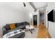 Open living area with hardwood floors, gray sectional sofa, and large windows at 800 Peachtree Ne St # 8607, Atlanta, GA 30308
