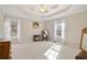 Well-lit bedroom featuring two windows, hardwood floors, and a ceiling fan at 304 Stations Ave, Woodstock, GA 30189