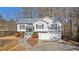 House exterior showcasing a two-car garage and well-manicured lawn at 304 Stations Ave, Woodstock, GA 30189