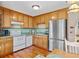 Bright kitchen with stainless steel appliances and wood cabinetry at 304 Stations Ave, Woodstock, GA 30189