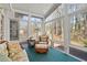 Bright sunroom with wicker furniture and view of backyard at 304 Stations Ave, Woodstock, GA 30189