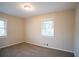 Simple bedroom with carpet and two windows at 3854 Brookcrest Cir, Decatur, GA 30032