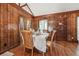 Dining area with hardwood floors and wood paneled walls at 434 Cana Of Galilee Ct, Tucker, GA 30084