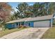 Ranch style home with blue siding, gray roof, and a two-car garage at 434 Cana Of Galilee Ct, Tucker, GA 30084