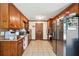 Galley kitchen with wood cabinets, stainless steel appliances, and tile floor at 434 Cana Of Galilee Ct, Tucker, GA 30084