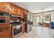 Kitchen featuring wood cabinets, stainless steel appliances, and tile flooring at 434 Cana Of Galilee Ct, Tucker, GA 30084