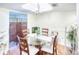 Dining room with glass table, four chairs, and a room divider at 6034 Regent Mnr, Lithonia, GA 30058