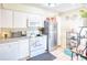 White kitchen with stainless steel appliances and granite countertops at 6034 Regent Mnr, Lithonia, GA 30058