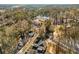 Aerial view of homes nestled in a wooded area with city skyline in the distance at 1399 Knob Hill Se Ct, Atlanta, GA 30316