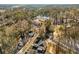Wide aerial view showcasing a residential neighborhood surrounded by mature trees and light snow dusting at 1399 Knob Hill Se Ct, Atlanta, GA 30316