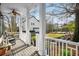 Inviting back porch with rocking chairs, overlooking a lush backyard and a charming garage at 1399 Knob Hill Se Ct, Atlanta, GA 30316