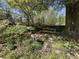 Serene backyard featuring a bird bath, wood bench, lush greenery and blooming azaleas creating a relaxing retreat at 1399 Knob Hill Se Ct, Atlanta, GA 30316