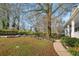 Landscaped backyard with a garden, picnic table and mature trees at 1399 Knob Hill Se Ct, Atlanta, GA 30316