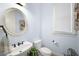 Charming bathroom featuring a white vanity, oval mirror, and bright natural lighting at 1399 Knob Hill Se Ct, Atlanta, GA 30316