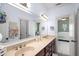 Bright bathroom featuring double sinks, large mirror, neutral counter, and view to Bedroom room at 1399 Knob Hill Se Ct, Atlanta, GA 30316