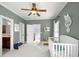 Spacious Bedroom with a crib, neutral green walls, view to a staircase, and ample natural light at 1399 Knob Hill Se Ct, Atlanta, GA 30316