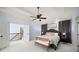Large bedroom with tray ceiling, ceiling fan, sitting bench, and view to second story landing at 1399 Knob Hill Se Ct, Atlanta, GA 30316