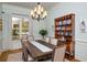 Elegant dining room boasts a chandelier, large window and built-in hutch showcasing fine china at 1399 Knob Hill Se Ct, Atlanta, GA 30316