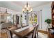 Chandelier-lit dining room with a view into the living room and a large sunny window at 1399 Knob Hill Se Ct, Atlanta, GA 30316