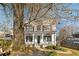 Charming two-story white home featuring a welcoming front porch with ceiling fans and professionally landscaped yard at 1399 Knob Hill Se Ct, Atlanta, GA 30316