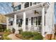 Spacious front porch with white columns, ceiling fan, and rocking chairs at 1399 Knob Hill Se Ct, Atlanta, GA 30316