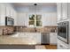 Spacious kitchen with white cabinets, granite countertops, and stainless steel appliances at 1399 Knob Hill Se Ct, Atlanta, GA 30316