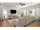 Bright living room showcasing an oversized couch, hardwood flooring, and natural light at 1399 Knob Hill Se Ct, Atlanta, GA 30316