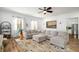 Inviting living room featuring a large sectional sofa, area rug, and natural light at 1399 Knob Hill Se Ct, Atlanta, GA 30316