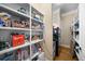Well-organized walk-in pantry with shelving and storage baskets, plus stainless steel appliances at 1399 Knob Hill Se Ct, Atlanta, GA 30316