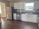 Modern kitchen featuring stainless steel appliances and dark brown vinyl flooring at 3690 Darrah Sw Way, Atlanta, GA 30331