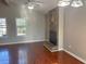 Living room with hardwood floors, stone fireplace, and ceiling fan at 3690 Darrah Sw Way, Atlanta, GA 30331