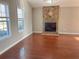 Living room with hardwood floors, stone fireplace, and ceiling fan at 3690 Darrah Sw Way, Atlanta, GA 30331