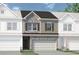 Two-story townhome with stone and siding exterior, two-car garage, and landscaping at 209 Bastian Dr # 4, Villa Rica, GA 30180