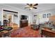 Cozy living room with hardwood floors, ceiling fan, stylish rug, and comfortable seating with views to the kitchen at 1327 Hosea L Williams Se Dr, Atlanta, GA 30317