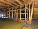 The attic has exposed wooden beams and yellow floor covering at 1643 Westhaven Sw Dr, Atlanta, GA 30311