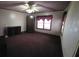 Bedroom with an armoire, dresser, wood framed window, and burgundy carpet at 1643 Westhaven Sw Dr, Atlanta, GA 30311