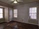 Bedroom featuring hardwood floors, blinds, and a white wooden door and trim at 1643 Westhaven Sw Dr, Atlanta, GA 30311