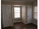 Bedroom featuring two doors, a window, and hardwood floors at 1643 Westhaven Sw Dr, Atlanta, GA 30311