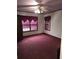 Bedroom featuring carpet floors, two windows, and a ceiling fan, awaiting personal touches to make it your own at 1643 Westhaven Sw Dr, Atlanta, GA 30311