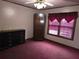 Bedroom with red carpet, dark wood furniture, and a window with dark red curtains at 1643 Westhaven Sw Dr, Atlanta, GA 30311