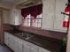 Kitchen featuring white cabinets, laminate counters, and a large window at 1643 Westhaven Sw Dr, Atlanta, GA 30311