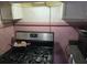 Stainless steel stove top and pink tile backsplash at 1643 Westhaven Sw Dr, Atlanta, GA 30311